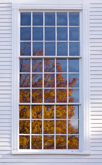 Autumn Tree Reflection in Window of Old Baptist Meeting House
